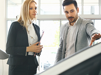 Sales representative showing prospect the features of their product.